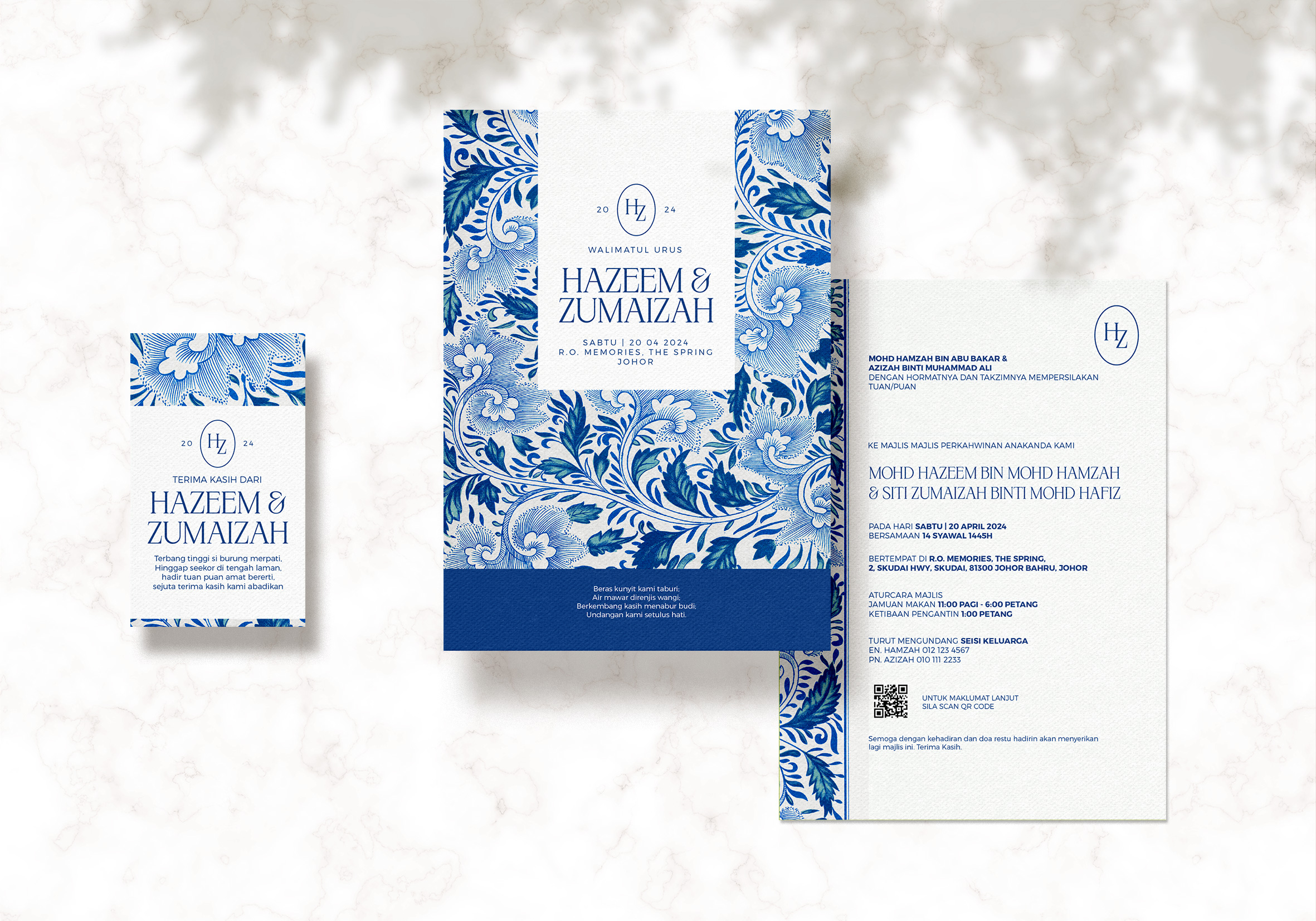 Blue-themed wedding invitation with intricate floral patterns.